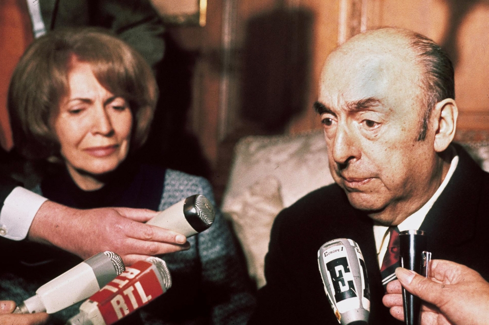 In this file photo taken on October 21, 1971 Chilean writer, poet and diplomat Pablo Neruda, then ambassador in France, answers journalists' questions, next to his wife at the Chilean embassy in Paris after being awarded the 1971 Nobel Literature Prize. (AFP)