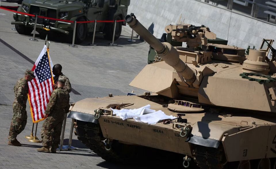 US soldiers stand with Polish and US flags near M1/A2 Abrams tank outside a hall of 30th International Defence Industry Exhibition in Kielce, Poland on September 5, 2022. File Photo / Reuters
