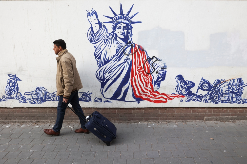 An Iranian man walks past an anti-U.S. mural on the wall of former U.S. Embassy in Tehran, Iran on January 25, 2023. Majid Asgaripour/WANA (West Asia News Agency)/Handout via REUTERS 
