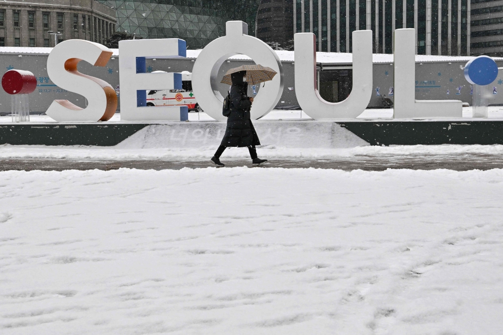 Woman walking along snow-covered street in front of City Hall in Seoul, South Korea. File photo for representational purposes only.