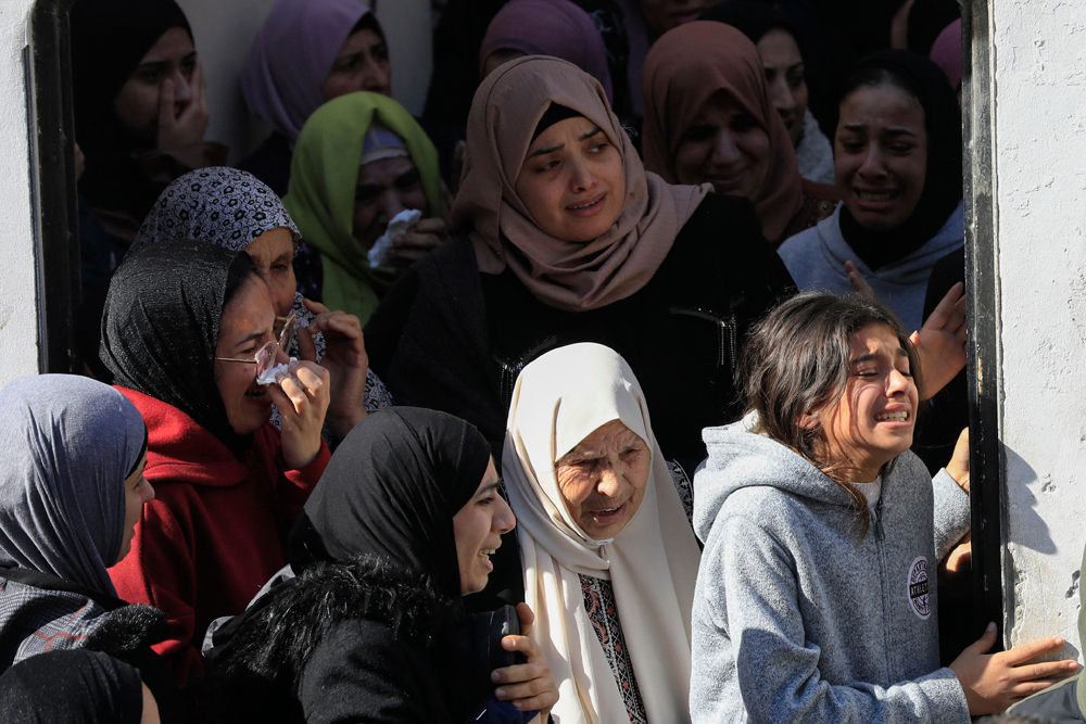 Palestinian women mourn at the funeral of one of the victims killed during an Israeli raid on the Jenin refugee camp in the occupied West Bank, yesterday. (AFP)