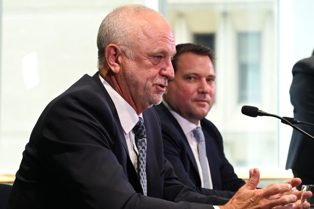Graham Arnold (L) speaks to the media during a press conference announcing the Australian men's football team head coach in Sydney on January 30, 2023. (Photo by Muhammad FAROOQ / AFP)