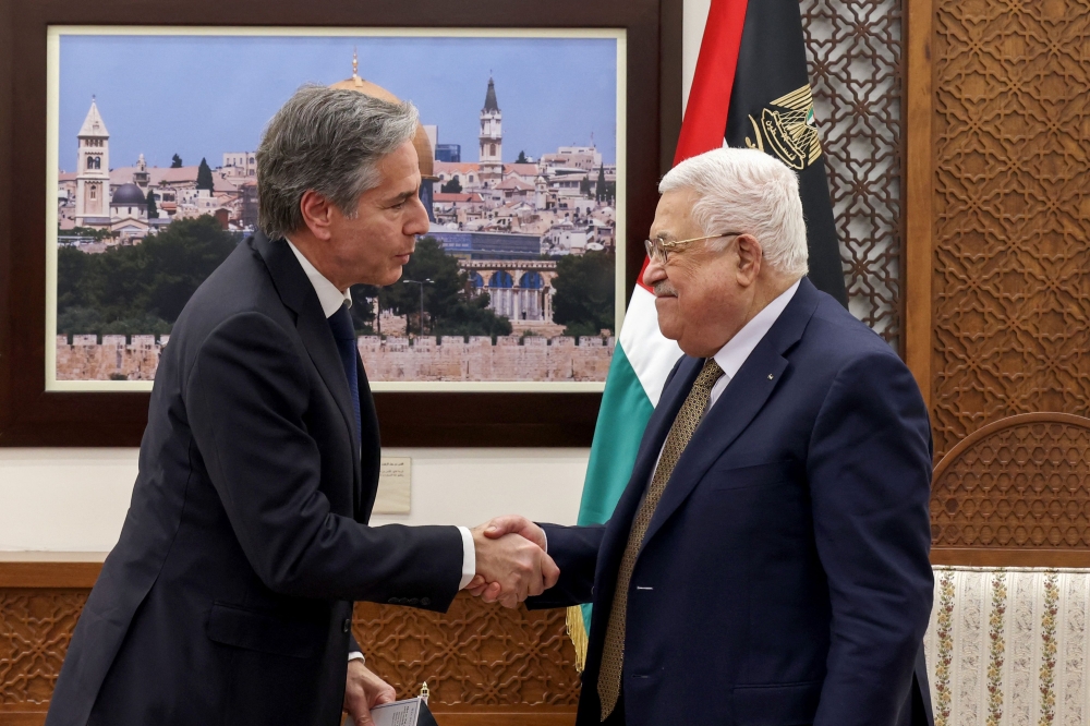 Palestinian President Mahmud Abbas (right) and US Secretary of State Antony Blinken shake hands following their meeting in Ramallah in the occupied West Bank, on January 31, 2023. (Photo by RONALDO SCHEMIDT / POOL / AFP)