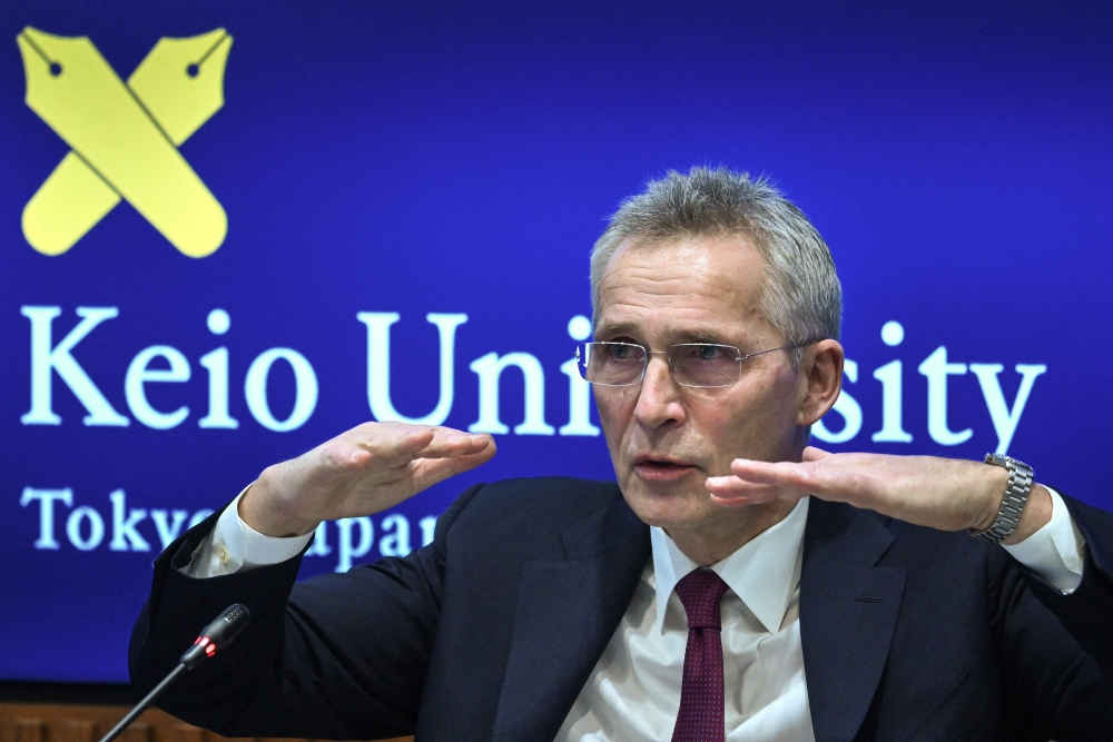 NATO Secretary General Jens Stoltenberg gestures as he answers questions during a visit and presentation at Keio University in Tokyo on February 1, 2023. (Photo by Richard A. Brooks / AFP)