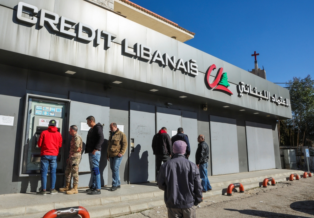 People gather outside a fortified Credit Libanais Bank in Chtaura, Lebanon, January 20, 2023. REUTERS/Mohamed Azakir