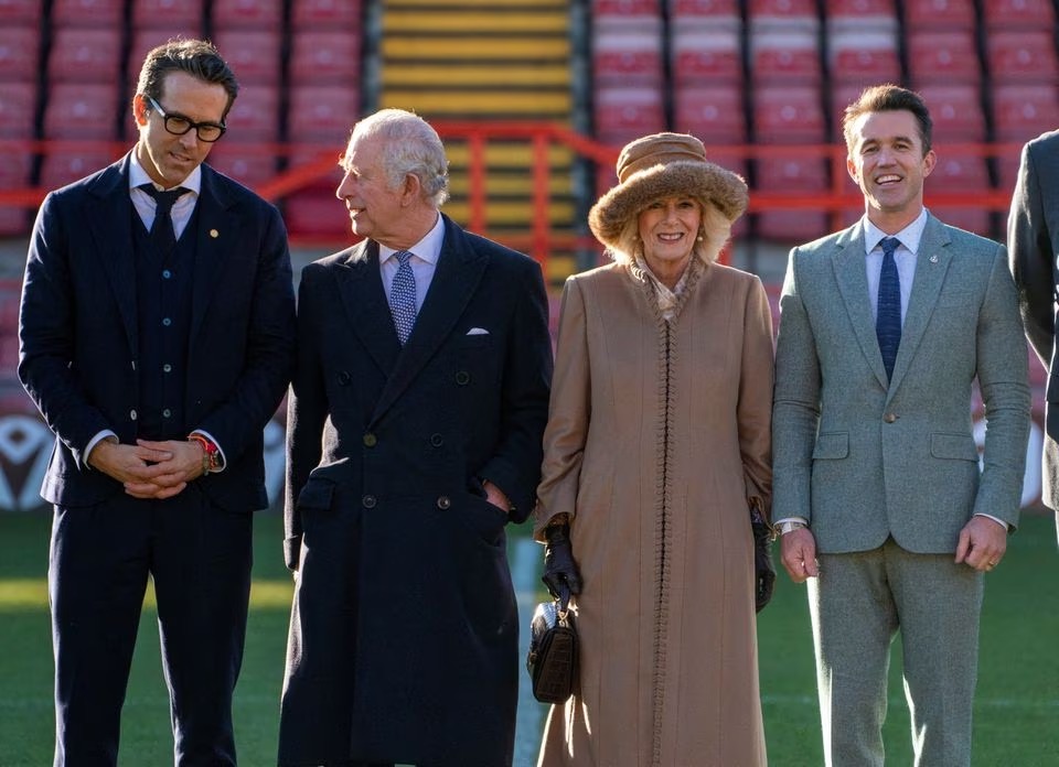FILE PHOTO: The King and The Queen Consort visited Wrexham Association Football Club (AFC). Hollywood actors, Ryan Reynolds and Rob McElhenney bought the club in 2021. Arthur Edwards/Pool via REUTERS