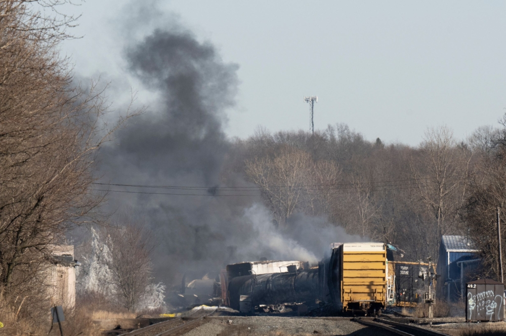 Smoke rises from a derailed cargo train in East Palestine, Ohio, on February 4, 2023. (Photo by Dustin Franz / AFP)