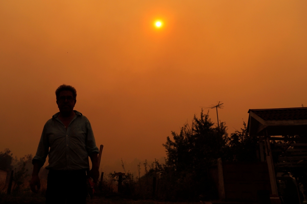 A man is seen during a fire in Santa Juana, Concepcion province, Chile on February 3, 2023. - Chile has declared a state of disaster in several central-southern regions after a devastating heat wave provoked forest fires that left four people dead, authorities said on Friday. (Photo by JAVIER TORRES / AFP)