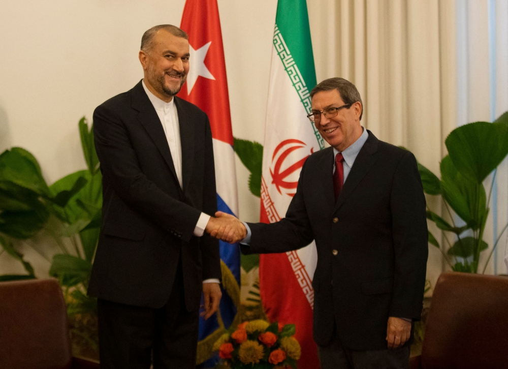Cuban Foreign Affairs Minister Bruno Rodriguez (R) and Iranian Foreign Minister Hossein Amir-Abdollahian (L) shake hands before a meeting at the Revolution Palace in Havana on February 4, 2023. (Photo by Yander ZAMORA / POOL / AFP)