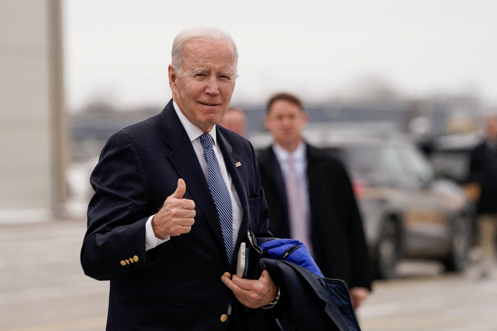 US President Joe Biden gestures to reporters before boarding Air Force One en route to Camp David at Hancock Field Air National Guard Base in Syracuse, New York, US, February 4, 2023. REUTERS/Elizabeth Frantz