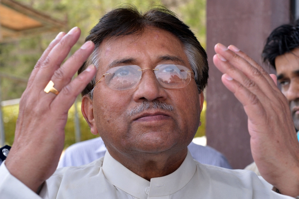 In this file photo taken on March 24, 2013 Pakistan's former military ruler Pervez Musharraf prays after arriving at the Karachi International airport from Dubai. (Photo by Aamir Qureshi / AFP)