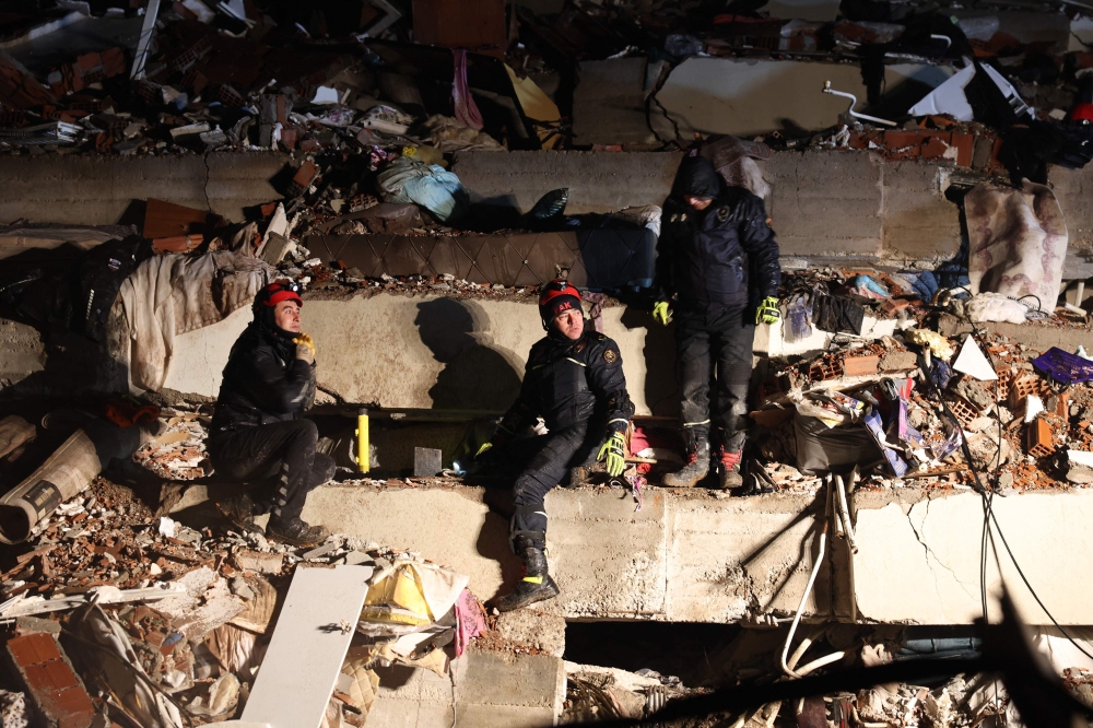 Rescuers search for victims and survivors amidst the rubble of collapsed buildings in Kahramanmaras, Turkey, after a 7.8-magnitude earthquake struck the country's southeast on February 7, 2023. Photo by Adem ALTAN / AFP