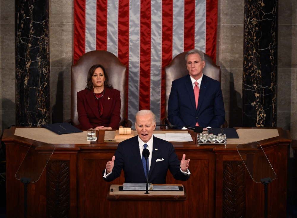 US Vice President Kamala Harris and US Speaker of the House Kevin McCarthy (R-CA) listen as US President Joe Biden delivers the State of the Union address, on February 7, 2023. (Photo by Andrew Caballero-Reynolds / AFP)