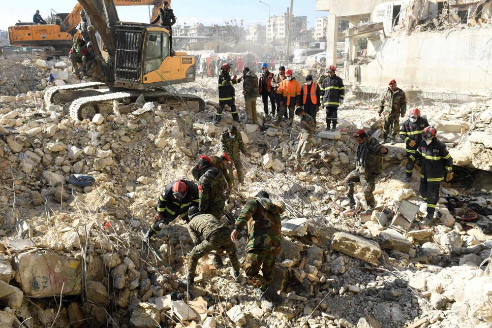 Algerian rescue teams take part in the search and rescue operations in Syria's northern city of Aleppo on February 8, 2023, two days after a deadly earthquake struck Syria and Turkey.   (Photo by AFP)