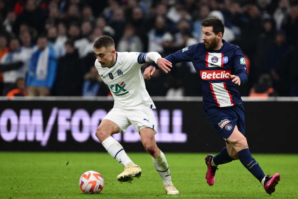 Marseille's French midfielder Valentin Rongier fights for the ball with Paris Saint-Germain's Argentine forward Lionel Messi during the French Cup round of 16 football match between Olympique Marseille (OM) and Paris Saint-Germain (PSG) at Stade Velodrome in Marseille, southern France on February 8, 2023. (Photo by CHRISTOPHE SIMON / AFP)