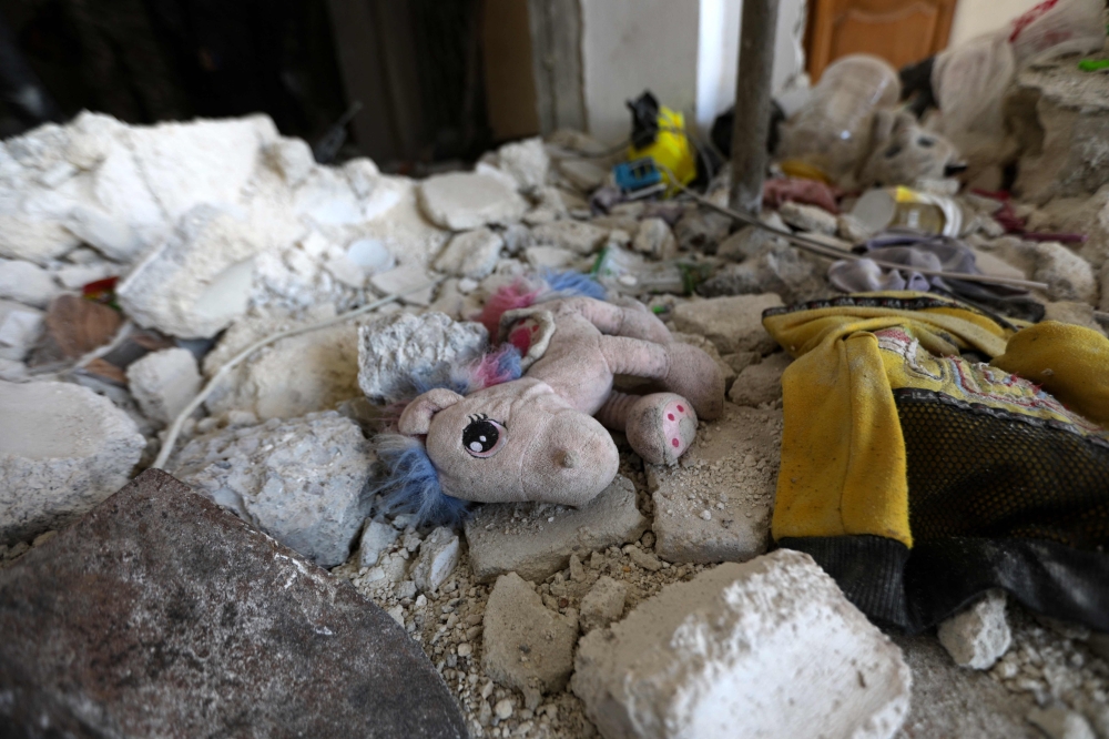 A child's toy lies amidst the rubble of a home destroyed in a deadly earthquake in the town of Jandaris, in Syria's rebel-held part of Aleppo province on February 9, 2023. (Photo by Bakr Alkasem / AFP)