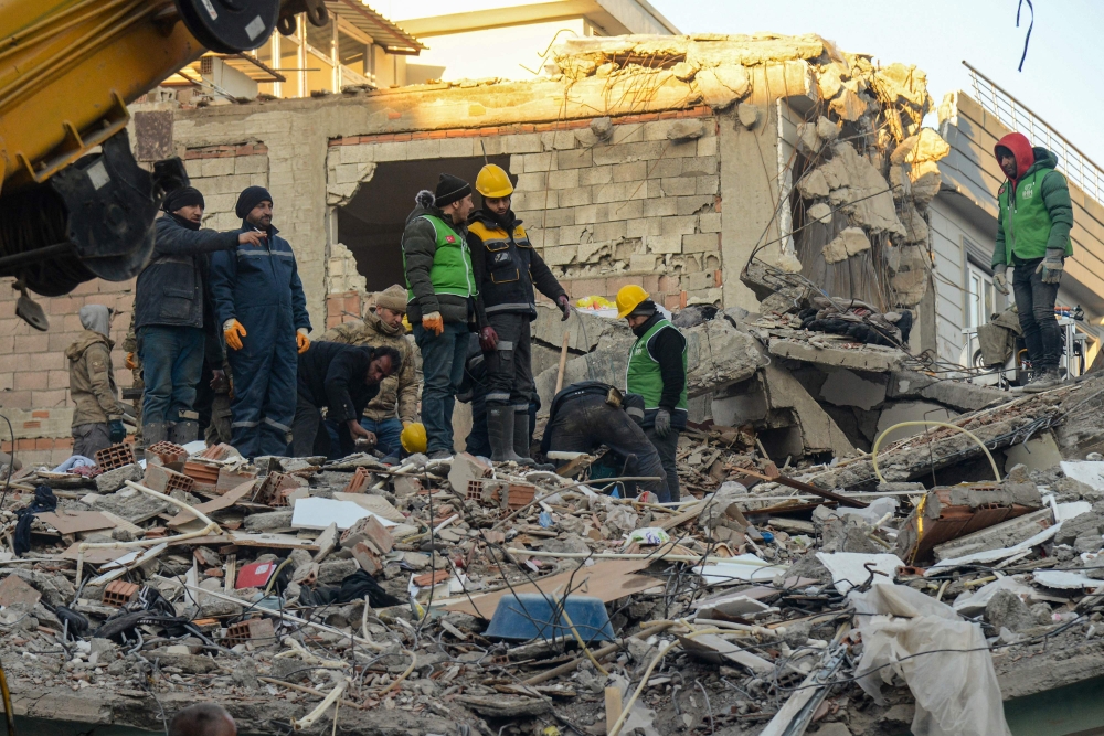 Rescuers carry out search operations among the rubble of a collapsed building in Adiyaman, Turkey on February 9, 2023, three days after a 7,8-magnitude earthquake struck southeast Turkey. Photo by Ilyas AKENGIN / AFP