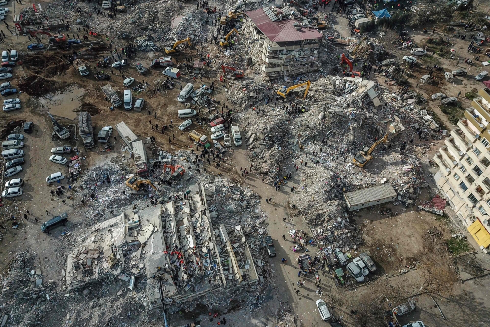 This aerial view shows collapsed buildings during ongoing rescue operation in Kahramanmaras, on February 10, 2023. (Photo by Ozan Kose / AFP)