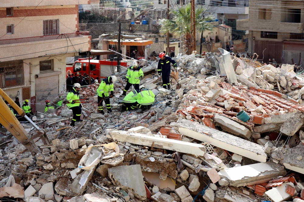 Rescuers sift through the rubble of a collapsed building in Jableh in the province of Latakia, northwest of the Syrian capital, on February 11, 2023. (Photo by Karim Sahib / AFP)