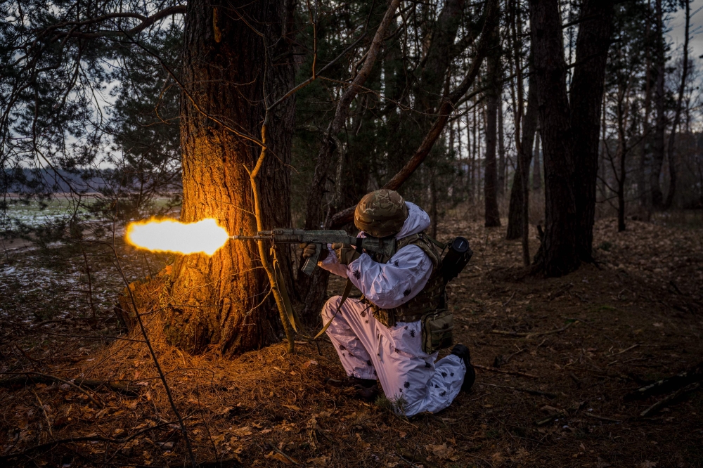 A Ukrainian serviceman fires during a joint military training of armed forces, national guards, border guards and Security Service of Ukraine in Rivne region, near the border with Belarus, on February 11, 2023, amid the Russian invasion of Ukraine. (Photo by Dimitar Dilkoff / AFP)