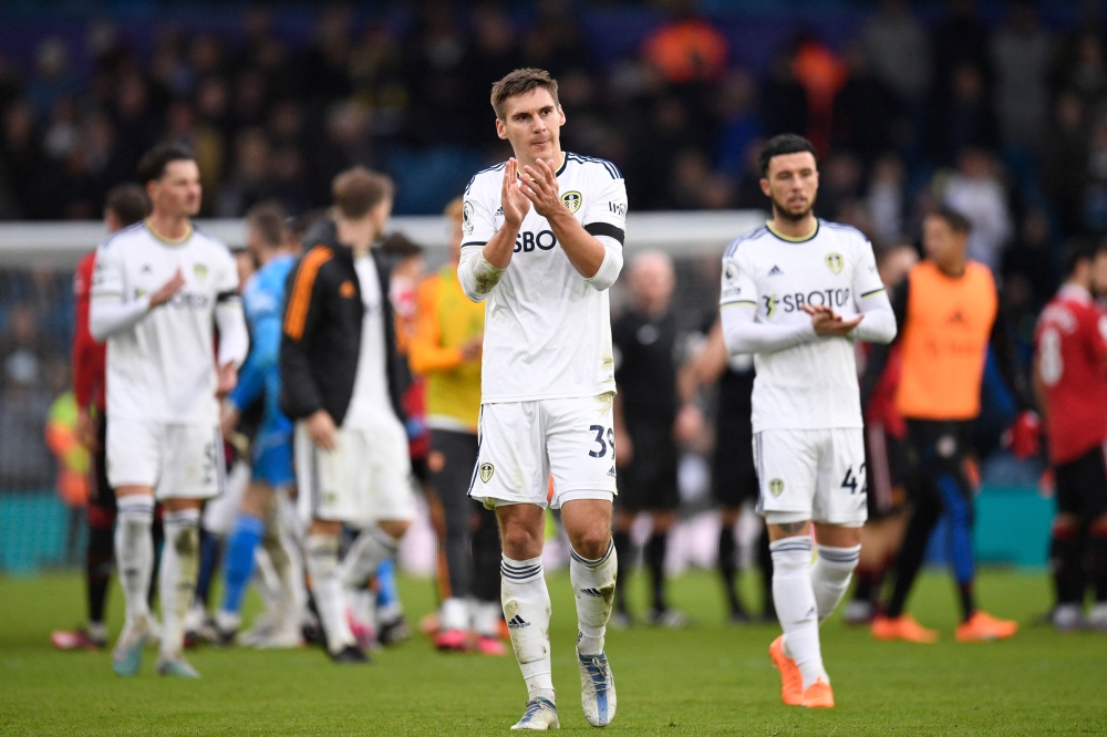 Leeds United's defender Maximilian Wober (center) applauds fans on the pitch after the English Premier League match between Leeds United and Manchester United at Elland Road in Leeds, northern England on February 12, 2023. - Man Utd won the game 2-0. (Photo by Oli SCARFF / AFP)