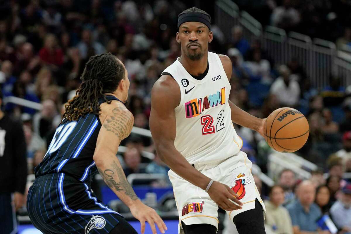 Miami Heat's Jimmy Butler (22) looks for a way around Orlando Magic's Cole Anthony, left, during the first half of an NBA basketball game, on February 11, 2023, in Orlando, Fla.John Raoux/AP
