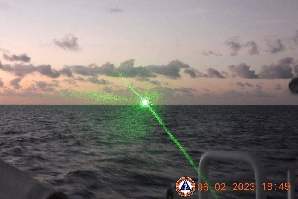 This handout photo taken on February 6, 2023 and released by the Philippine Coast Guard on February 13 shows a Chinese Coast Guard vessel shining a 