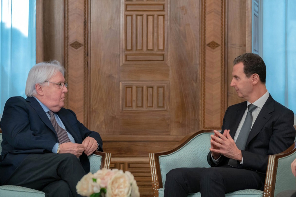 This handout picture released by the official Syrian Arab News Agency (SANA) shows Syria's President Bashar al-Assad (right) meeting with Martin Griffiths, the United Nations Under-Secretary-General for Humanitarian Affairs and Emergency Relief Coordinator, in the capital Damascus on February 13, 2023. (Photo by SANA / AFP) 
