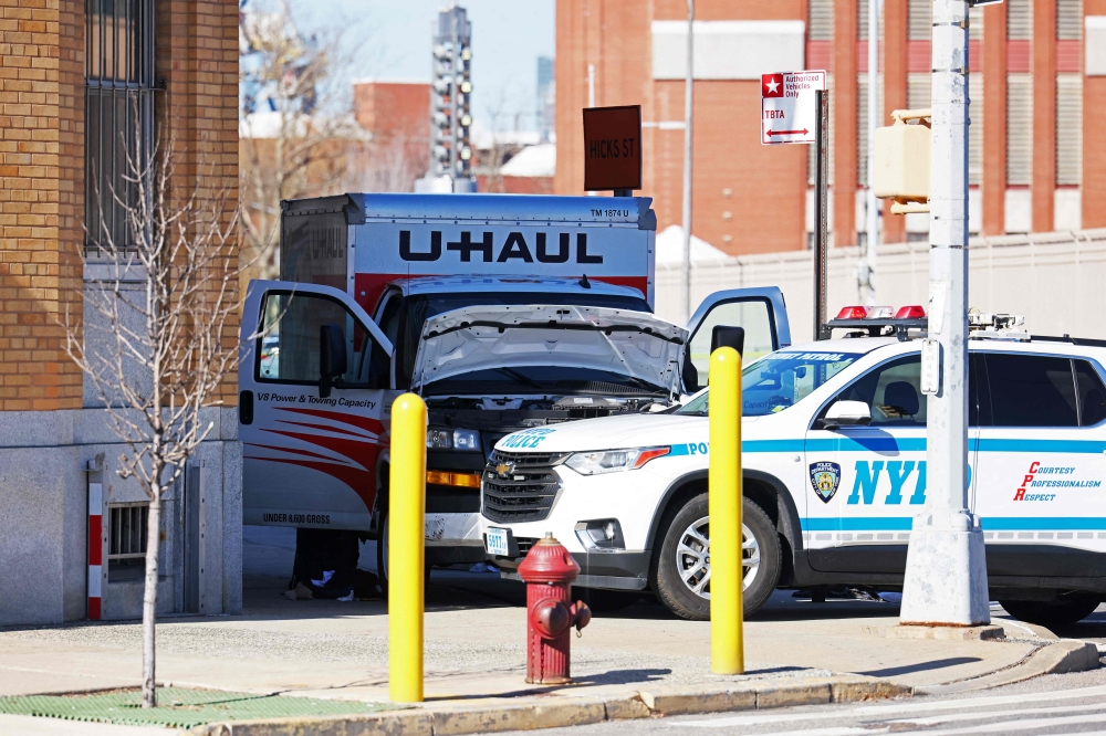 FEBRUARY 13: An NYPD vehicle is seen parked in front of a crashed U-Haul truck on Hamilton Avenue on February 13, 2023 in the Red Hook neighborhood of the Brooklyn borough in New York City. Photo by Michael M. Santiago / GETTY IMAGES NORTH AMERICA / Getty Images via AFP