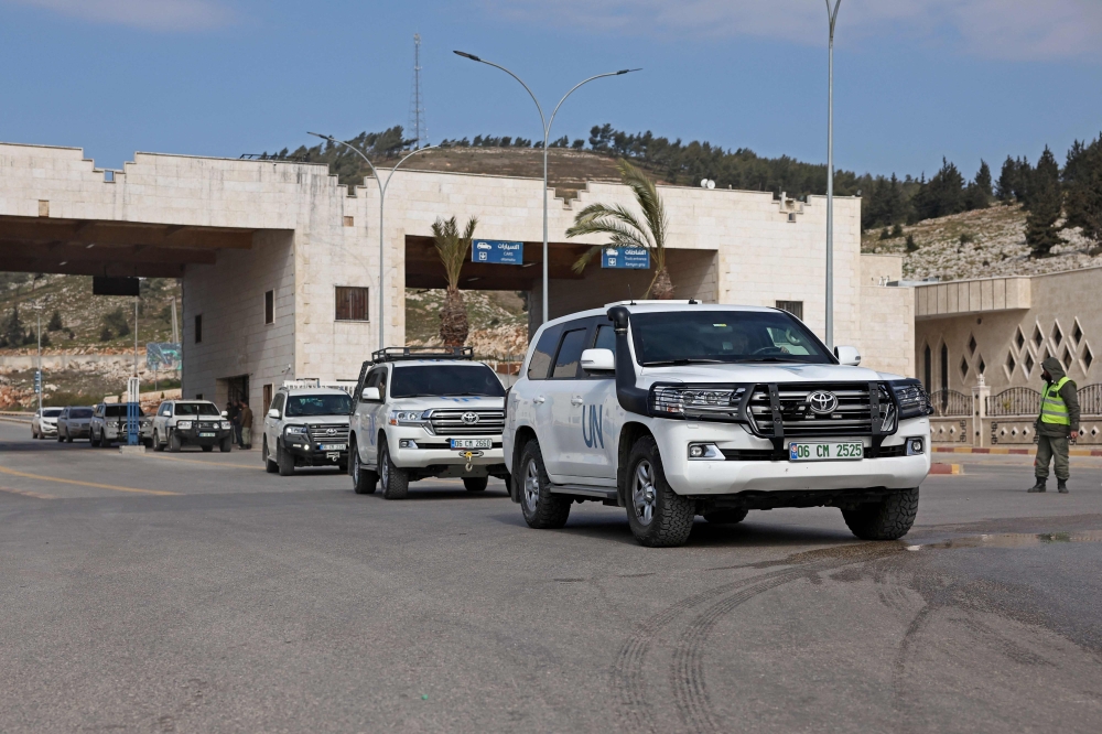 Vehicles carrying the first UN delegation to visit rebel-held northwestern Syria, arrive through the Bab al-Hawa border crossing with Turkey on February 14, 2023. (Photo by Omar HAJ KADOUR / AFP)