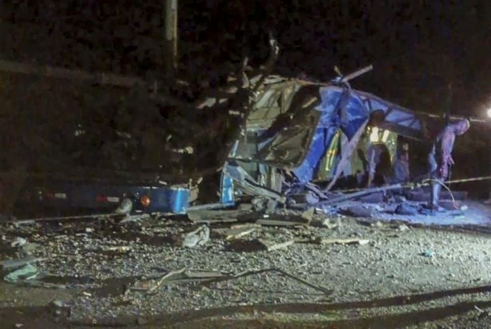 This handout picture released by Panama Chiriqui's Firefighters shows the aftermath of a bus transporting migrant people crashed, causing 39 deaths in Gualaca, Panama on February 15, 2023. (Photo by Panama Chiriqui's Firefighters / AFP)