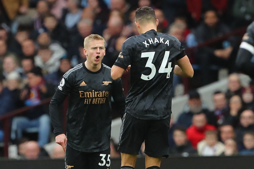 Arsenal's Ukrainian defender Oleksandr Zinchenko (left) celebrates with Arsenal's Swiss midfielder Granit Xhaka after scoring their second goal during the English Premier League match between Aston Villa and Arsenal at Villa Park in Birmingham, central England on February 18, 2023. (Photo by Geoff Caddick / AFP)