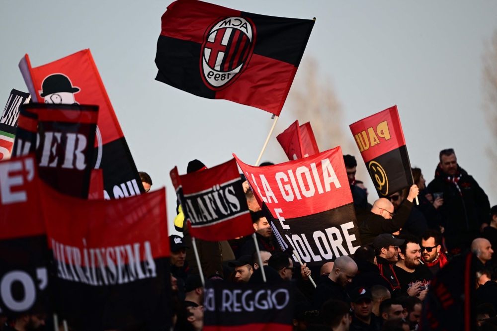 AC Milan fans cheer prior to the Italian Serie A football match between Monza and AC Milan on February 18, 2023 at the Brianteo Stadium in Monza. (Photo by Marco BERTORELLO / AFP)