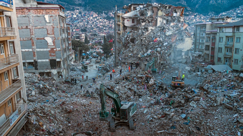 This aerial photograph taken on February 20, 2023 shows diggers removing the rubble of collapsed buildings in Antakya, southern Turkey. Photo by Sameer Al-DOUMY / AFP