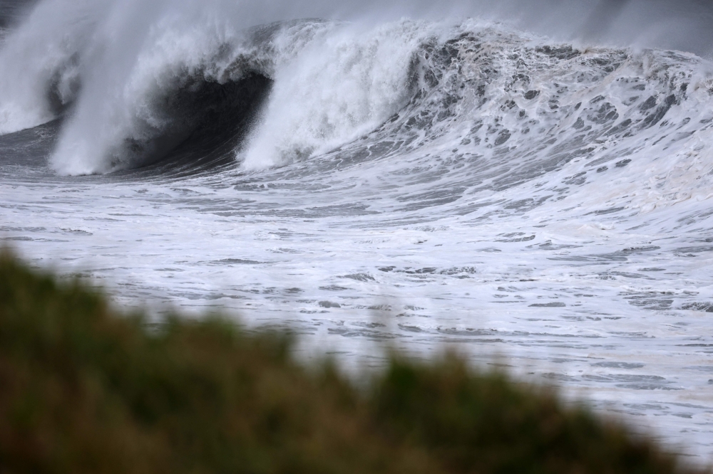 High waves crash along the shore as Cyclone Freddy nears the island at the village of Sainte-Anne, on the French overseas island of La Reunion on February 20, 2023. (Photo by Richard BOUHET / AFP)
