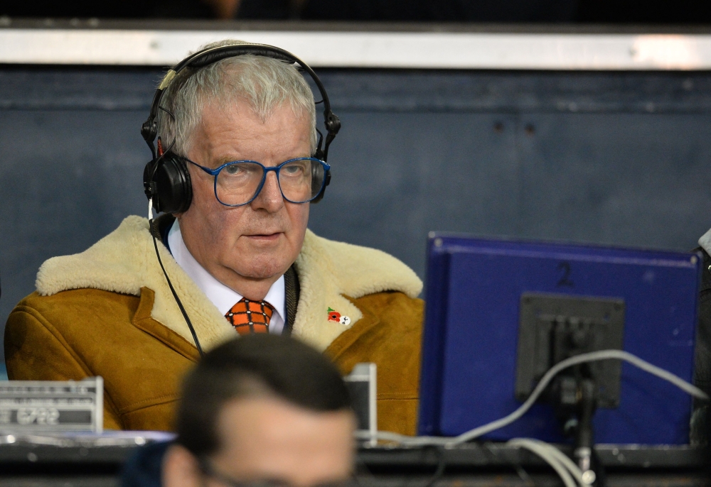 (FILES) In this file photo taken on November 2, 2015 BBC commenatator John Motson watches the English Premier League football match between Tottenham Hotspur and Aston Villa at White Hart Lane in north London. - Football commentator John Motson has died at the age of 77. (Photo by GLYN KIRK / AFP)