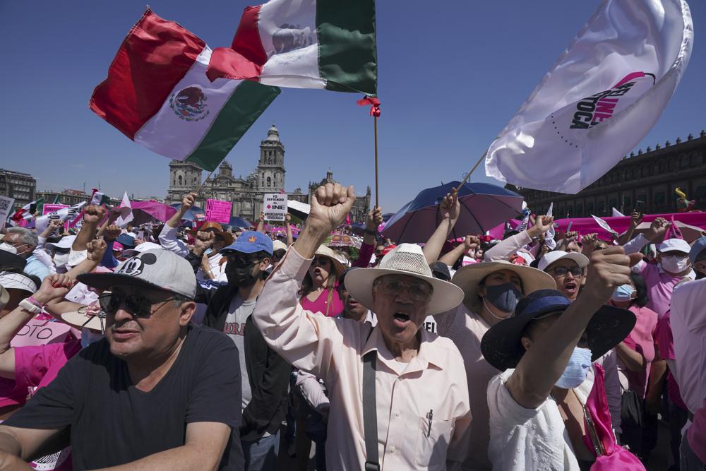 Anti-government demonstrators shout slogans against Mexican President Andres Manuel Lopez Obrador, during a march against recent reforms to the country's electoral law that they say threaten democracy, in Mexico City's main square, The Zocalo, Sunday, February 26, 2023. (AP Photo/Fernando Llano)