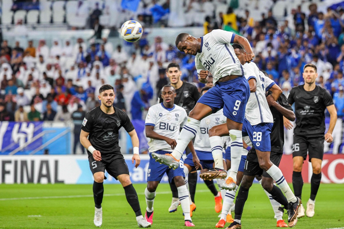 Al Hilal’s Nigerian forward Odion Ighalo (top) leaps to head the ball during the AFC Champions League semi-final against Al Duhail at Al Thumama Stadium in Doha yesterday. AFP