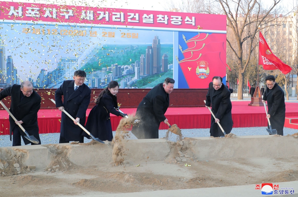 This photo taken on February 25, 2023 and released on February 26, 2023 by North Korea's official Korean Central News Agency (KCNA) shows North Korean leader Kim Jong Un (3rd R) and his daughter (3rd L) attending the ground-breaking ceremony for the construction of a new street at Sopho area of Pyongyang city. (Photo by KCNA via KNS / AFP) 