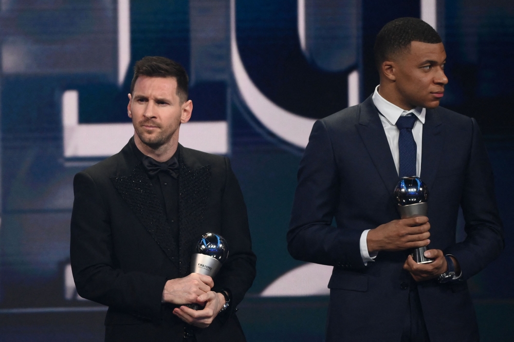 France and Paris Saint-Germain forward Kylian Mbappe and Argentina and Paris Saint-Germain forward Lionel Messi receive awards for the FIFA FIFPRO men's World11 during the Best FIFA Football Awards 2022 ceremony in Paris on February 27, 2023. (Photo by FRANCK FIFE / AFP)