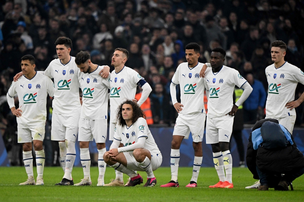 Marseille's players wait during the penalty shoutout of the French Cup quarter final football match between Olympique de Marseille and Annecy at the Velodrome stadium in Marseille, southern France, on March 1, 2023. (Photo by Nicolas TUCAT / AFP)