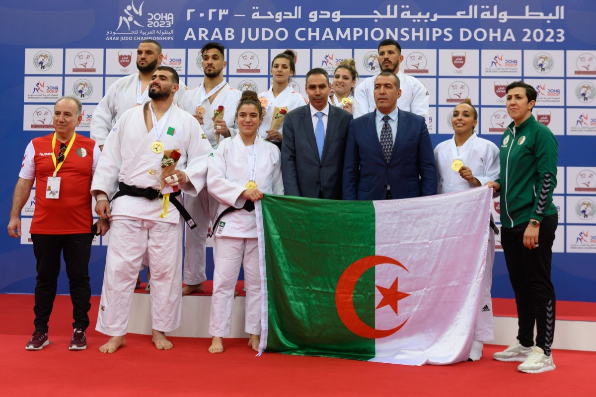 Team Algeria judokas pose for a photograph with officials. 