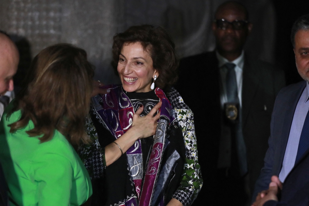 UNESCO chief Audrey Azoulay smiles as she is gifted a traditional dress during a visit to the national museum in Baghdad on March 6, 2023 as part of a three-day visit to Iraq where many priceless cultural treasures have been damaged or destroyed during decades of conflict. (Photo by AHMAD AL-RUBAYE / AFP)
