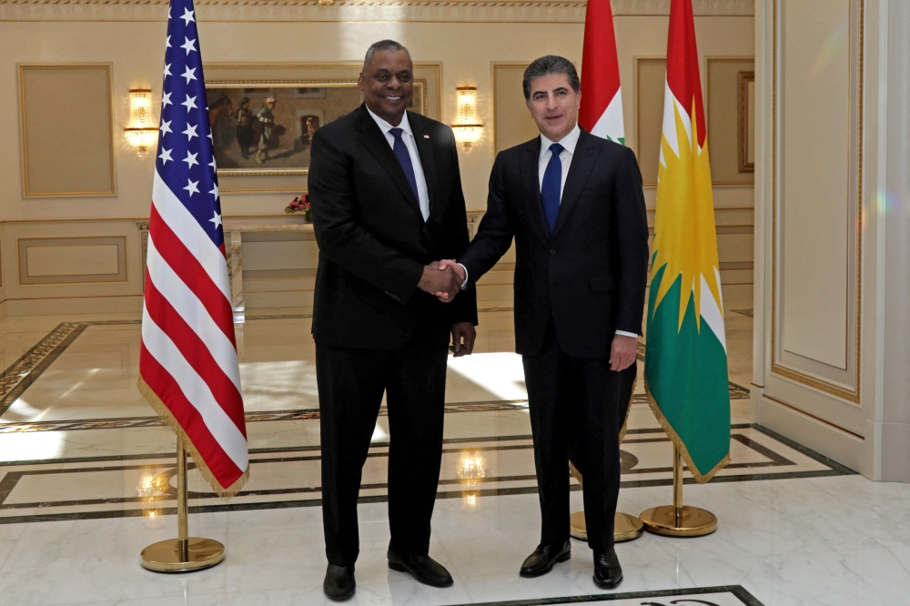 President of the Iraqi Kurdistan autonomous region Nechirvan Barzani (right) receives US Defense Secretary Lloyd Austin in Arbil on March 7, 2023. (Photo by SAFIN HAMED / AFP)