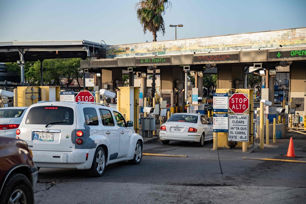 In this file photo taken on June 29, 2019 cars wait to cross into Brownsville, Texas from Matamoros, Mexico. - As reports swirl around the recent kidnapping in Mexico of four Americans, two of whom were killed, one detail has drawn particular attention -- they had crossed the border for a medical procedure. The revelation threw a spotlight on the steady stream of so-called medical tourism from the United States to its southern neighbor, as Americans cross the border seeking lower costs or treatments inaccessible at home, despite risks. (Photo by Sergio Flores / AFP)