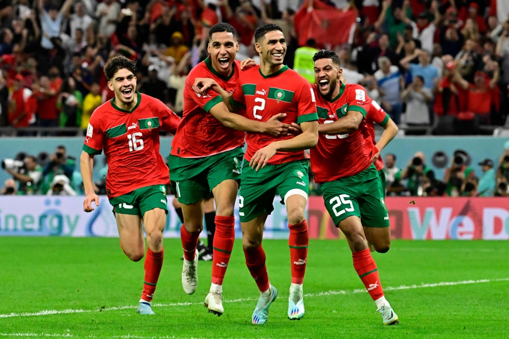 Morocco's defender Achraf Hakimi (centre) celebrates with teammates after converting the last penalty during the penalty shoot-out to win the Qatar 2022 World Cup round of 16 match between against Spain at the Education City Stadium in Al-Rayyan, west of Doha, on December 6, 2022. File photo / AFP