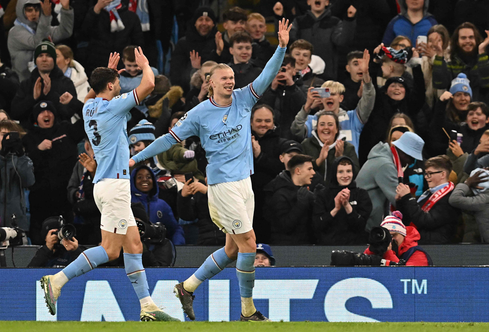 Manchester City’s Norwegian striker Erling Haaland (right) celebrates after scoring the team’s sixth goal, his fifth,  during the Champions League round of 16 second-leg match against RB Leipzig. AFP