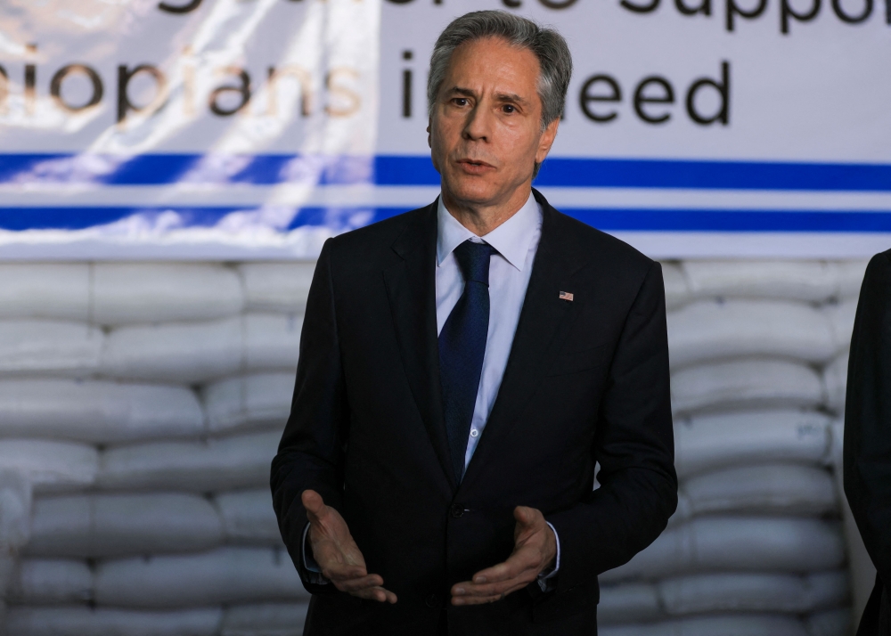 US Secretary of State Antony Blinken gestures as he speaks during a visit to a UN Logistics centre warehouse in Addis Ababa on March 15, 2023.  (Photo by TIKSA NEGERI / POOL / AFP)