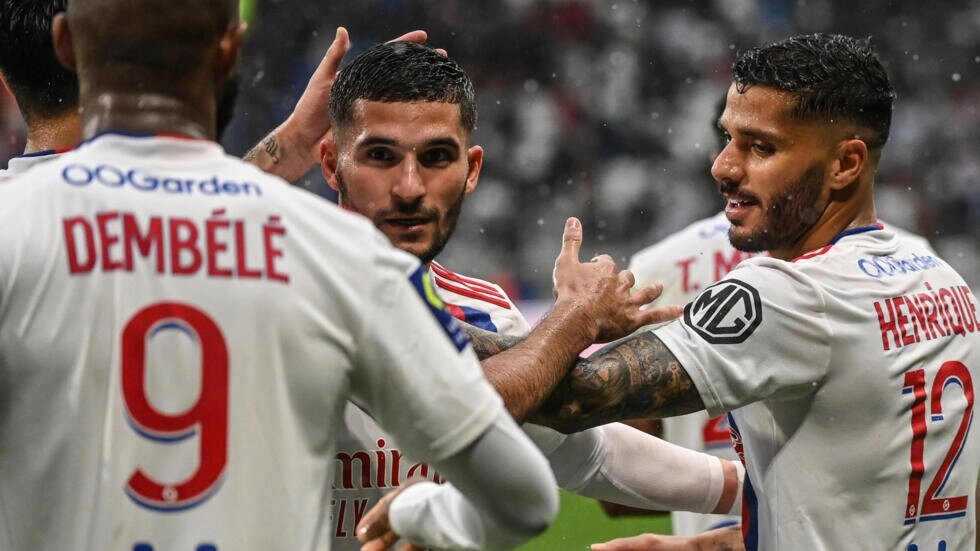 Houssem Aouar (centre) celebrates with team mates after scoring a goal during the French L1 football match between Lyon and Montpellier. OLIVIER CHASSIGNOLE / AFP
