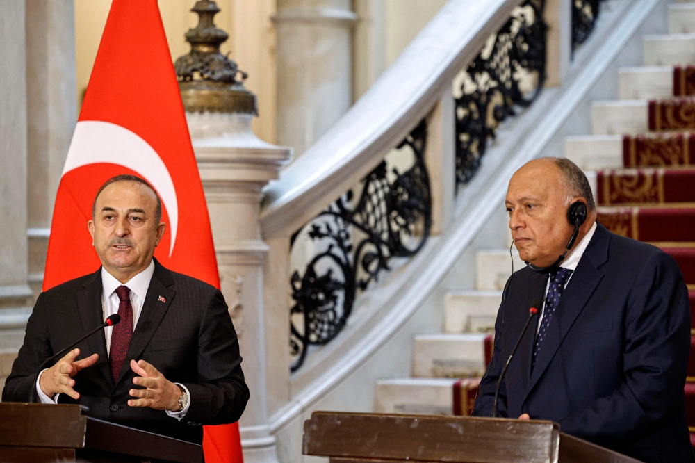 Egypt's Foreign Minister Sameh Shoukry (R) and his Turkish counterpart Mevlut Cavusoglu, give a joint press conference in Cairo, on March 18, 2023. (Photo by Khaled Desouki / AFP)